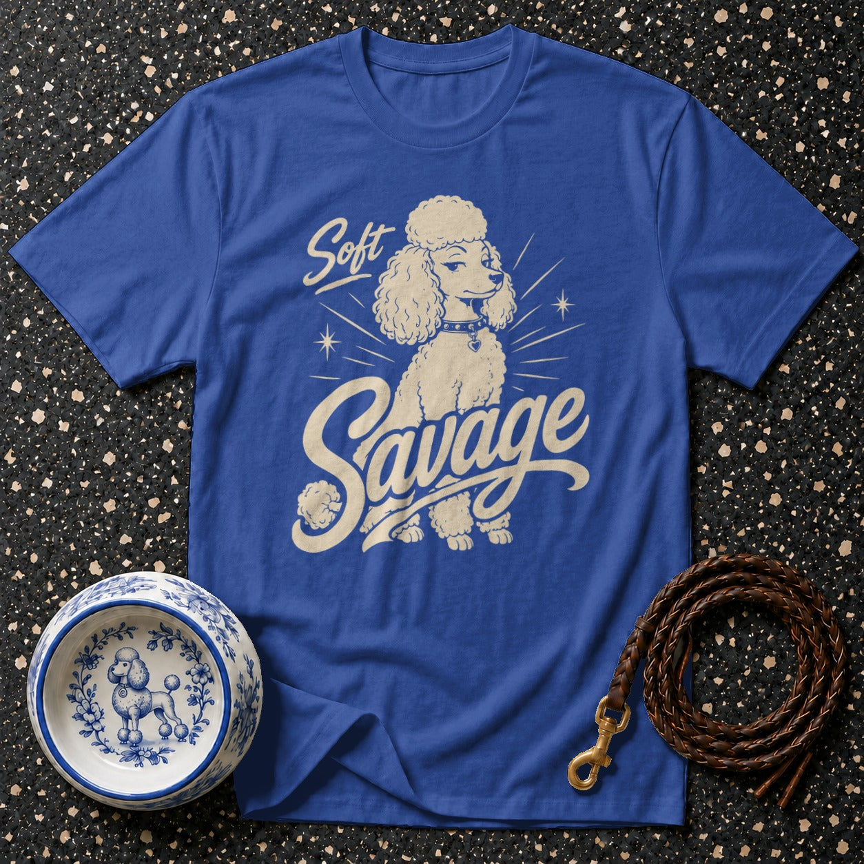 Blue t-shirt with a cream graphic of a poodle and text "Soft Savage".
