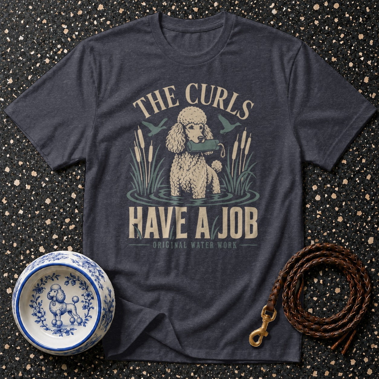 Dark grey t-shirt with a poodle in water and text "THE CURLS HAVE A JOB".