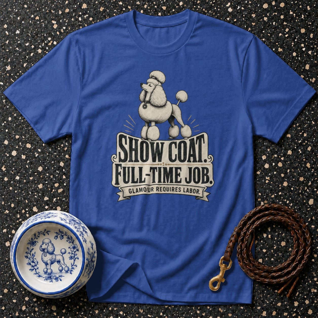 Blue t-shirt with a poodle graphic and text reading "SHOW COAT. FULL-TIME JOB. GLAMOUR REQUIRES LABOR."