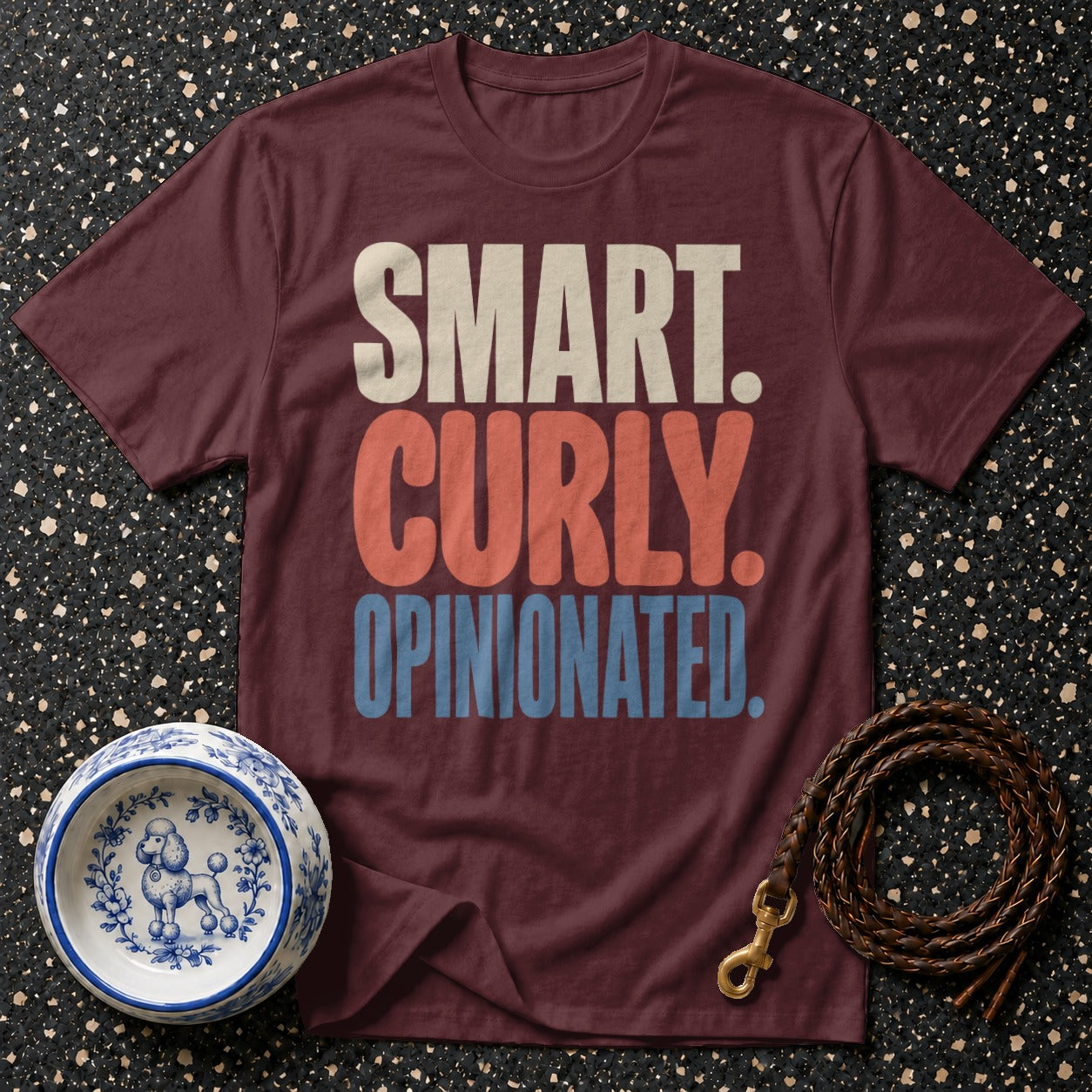Maroon t-shirt with "SMART. CURLY. OPINIONATED." text, dog bowl, and leash.
