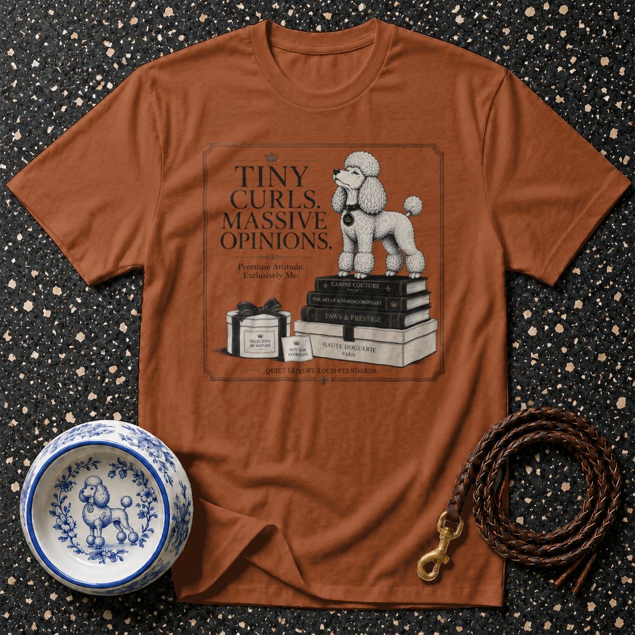 Brown t-shirt with the text and illustration of a poodle standing on books.