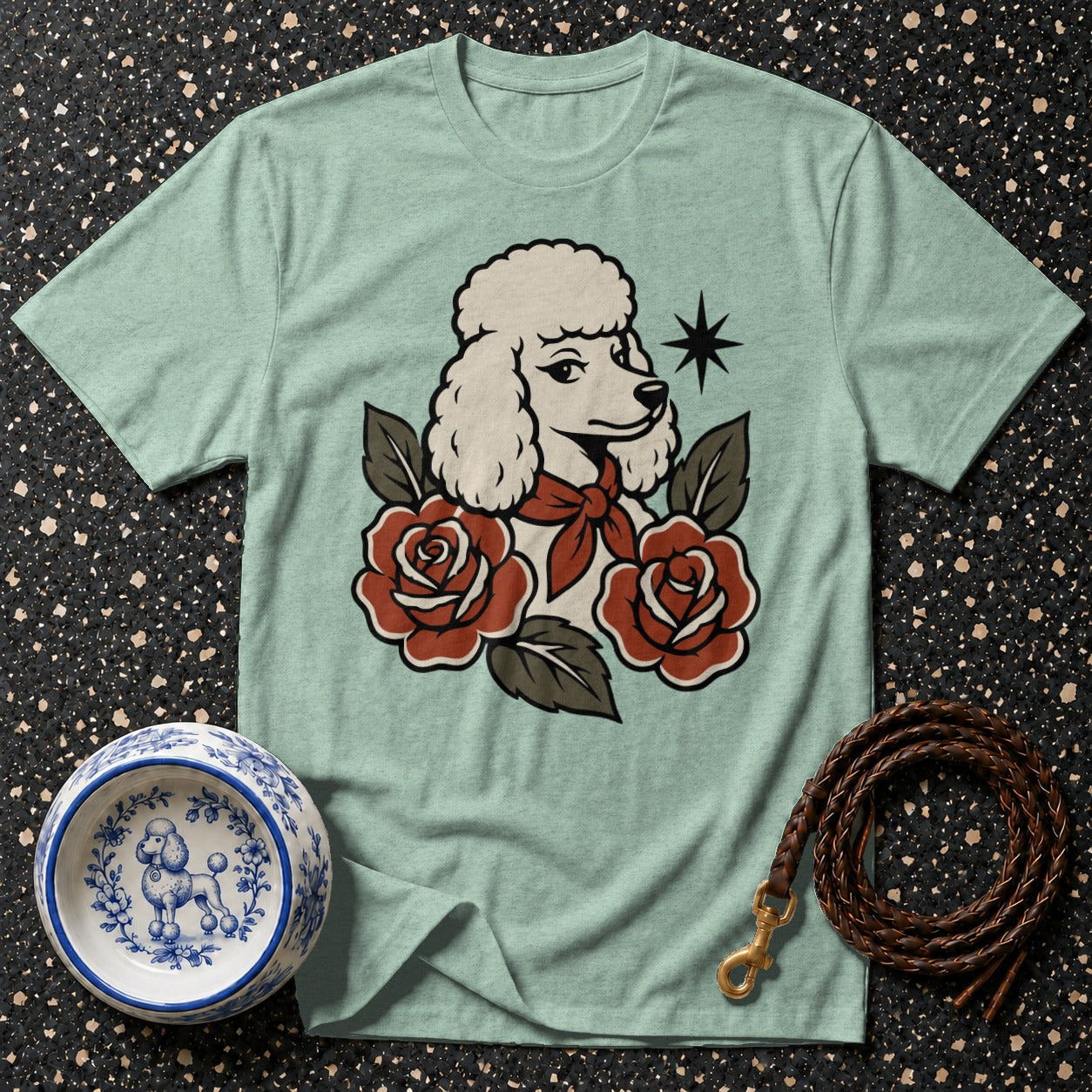 Light green t-shirt with poodle and rose graphic, dog bowl, and leash.