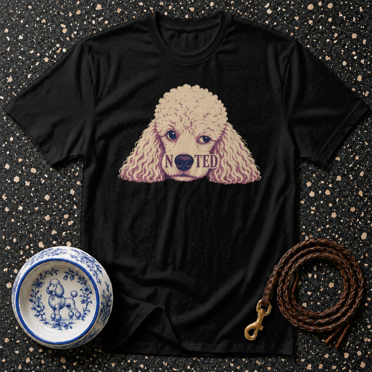 Black t-shirt with a poodle graphic and the word "NOTED".