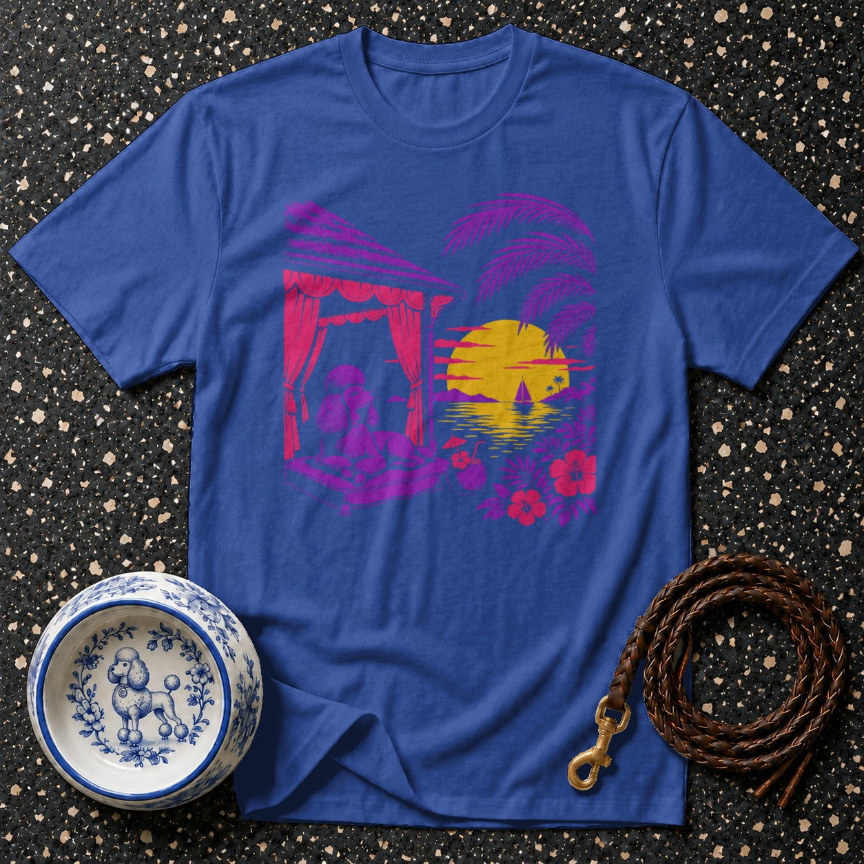 Blue t-shirt with a tropical sunset graphic featuring a dog in a cabana.