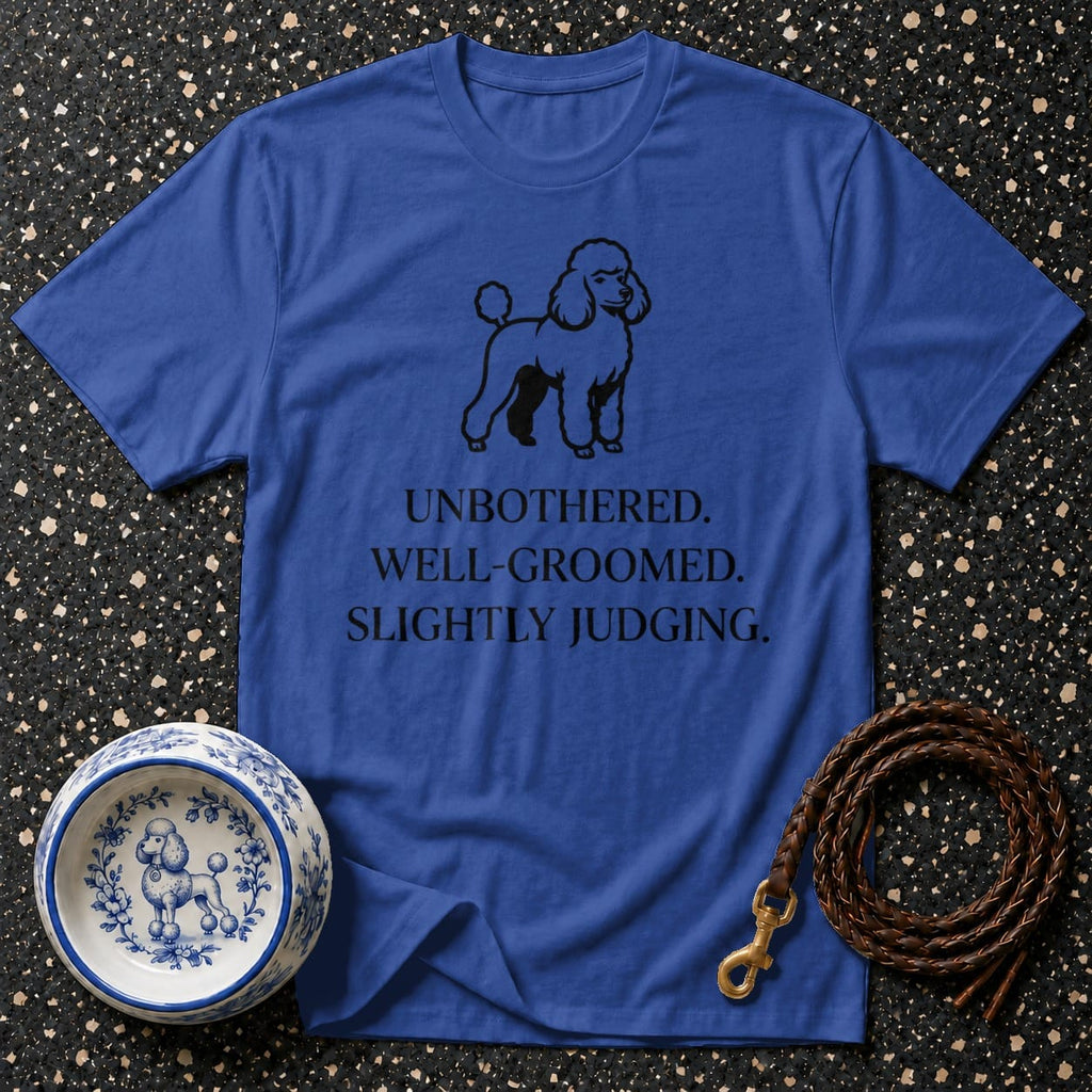 Blue t-shirt with black poodle graphic and text: UNBOTHERED. WELL-GROOMED. SLIGHTLY JUDGING.