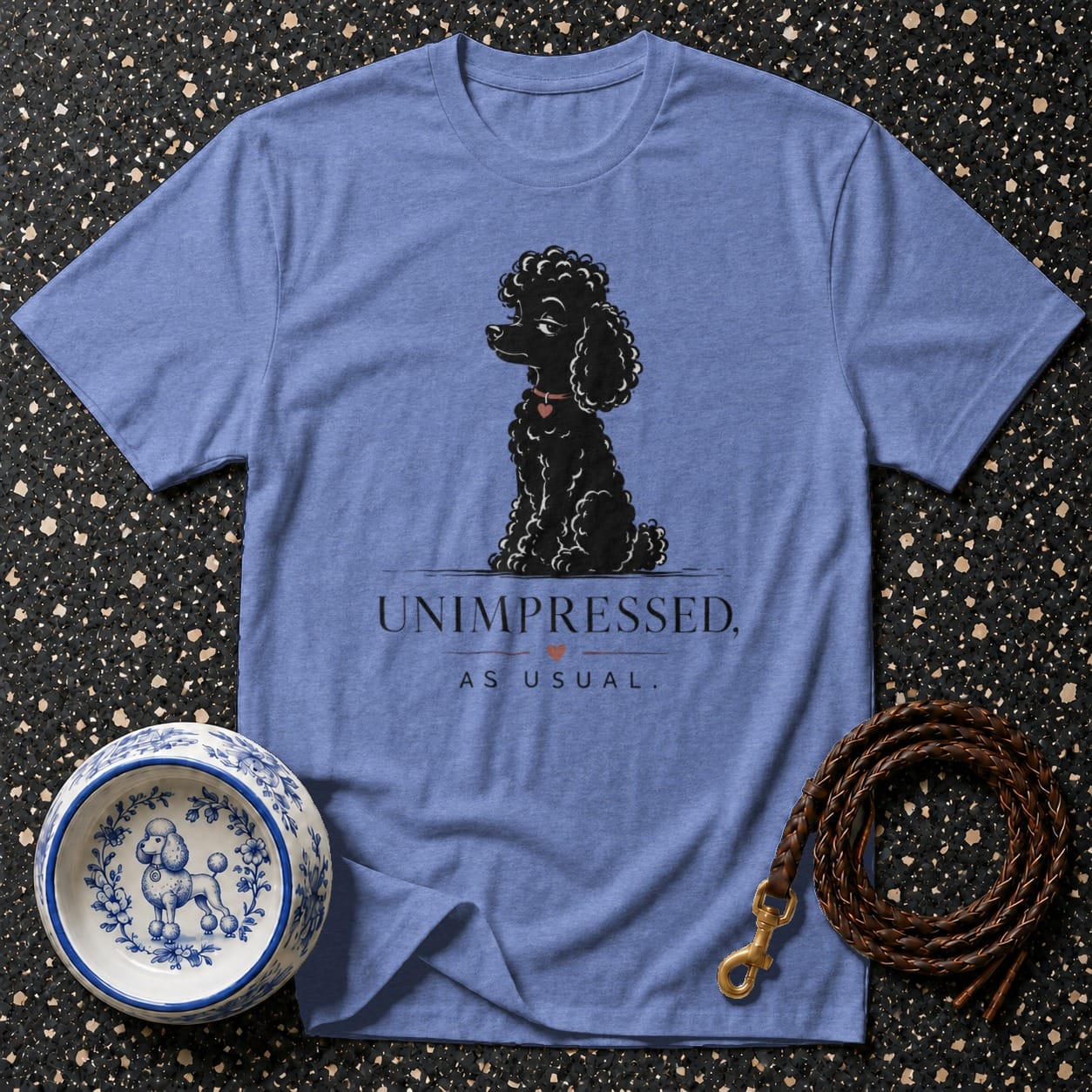 Blue t-shirt with black poodle illustration and text "Unimpressed, As Usual."