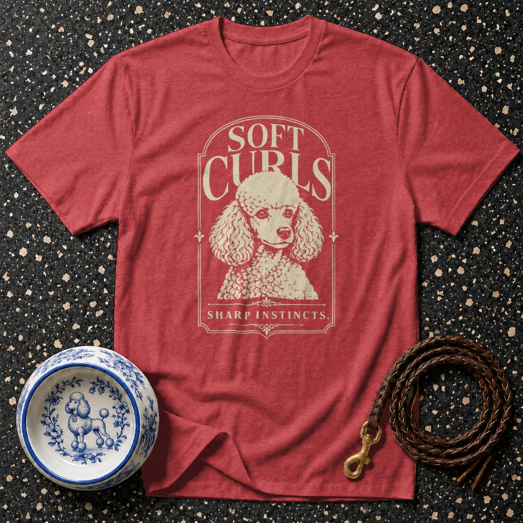 Red t-shirt with poodle graphic reading "SOFT CURLS SHARP INSTINCTS".