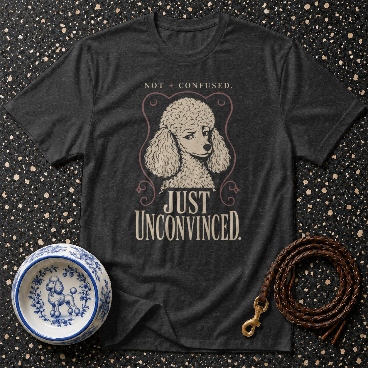 Dark grey t-shirt with poodle graphic and "NOT CONFUSED. JUST UNCONVINCED." text.