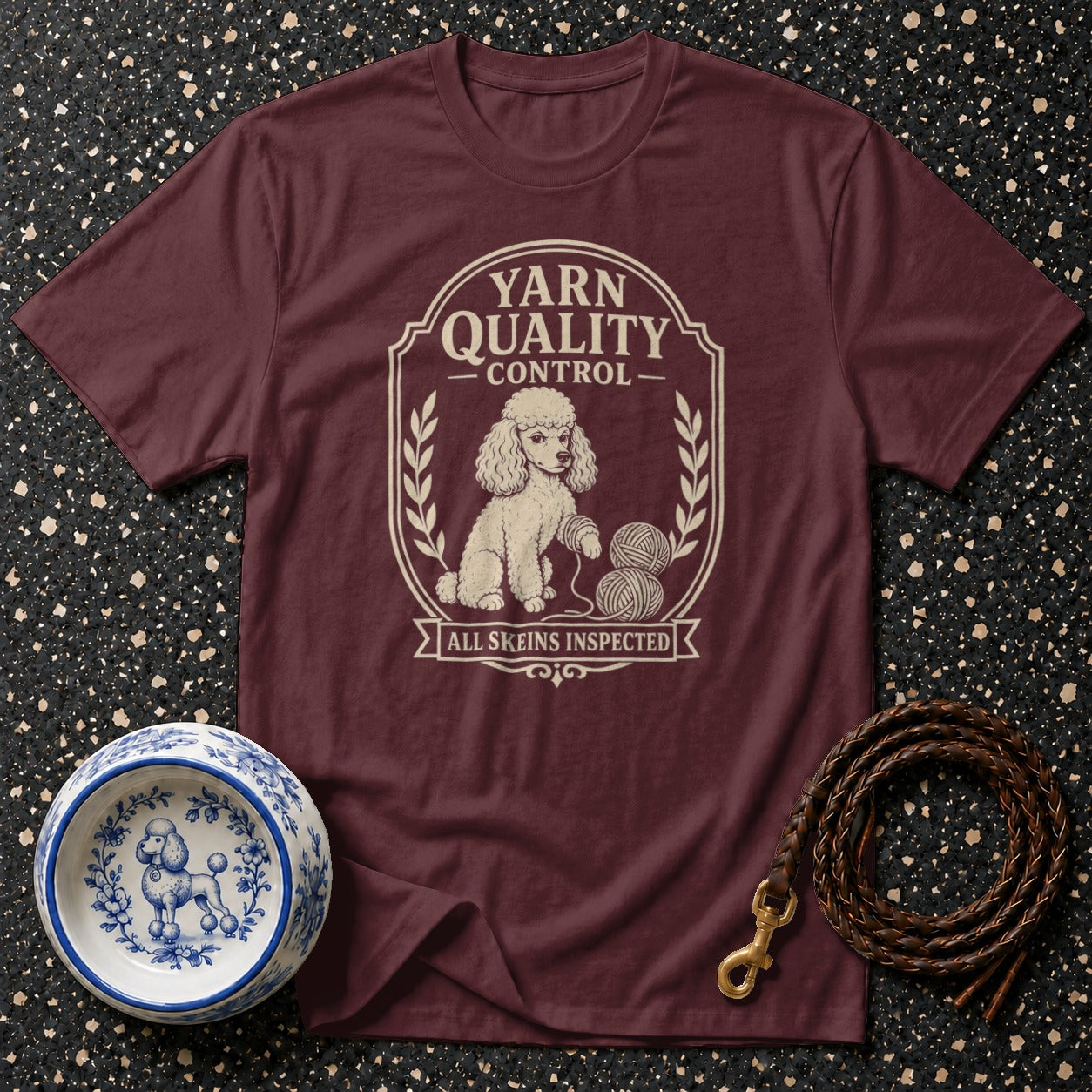 Maroon t-shirt with cream poodle and yarn graphic "Yarn Quality Control".