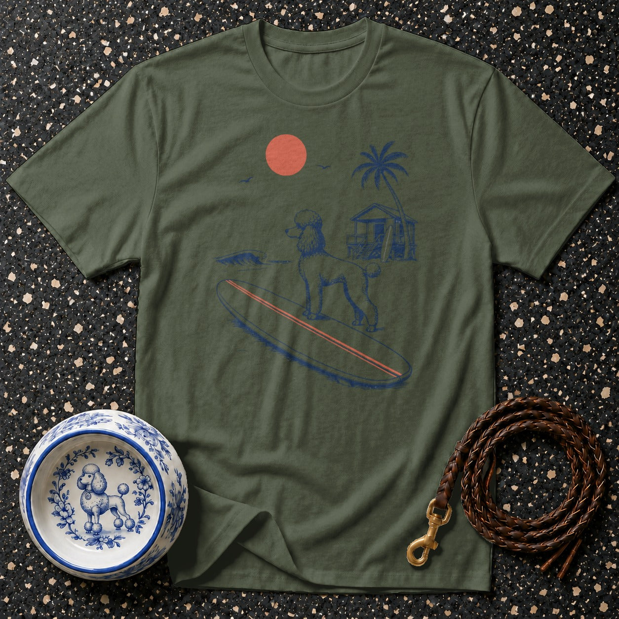 Green t-shirt with a poodle on a surfboard, beach, and sun graphic.
