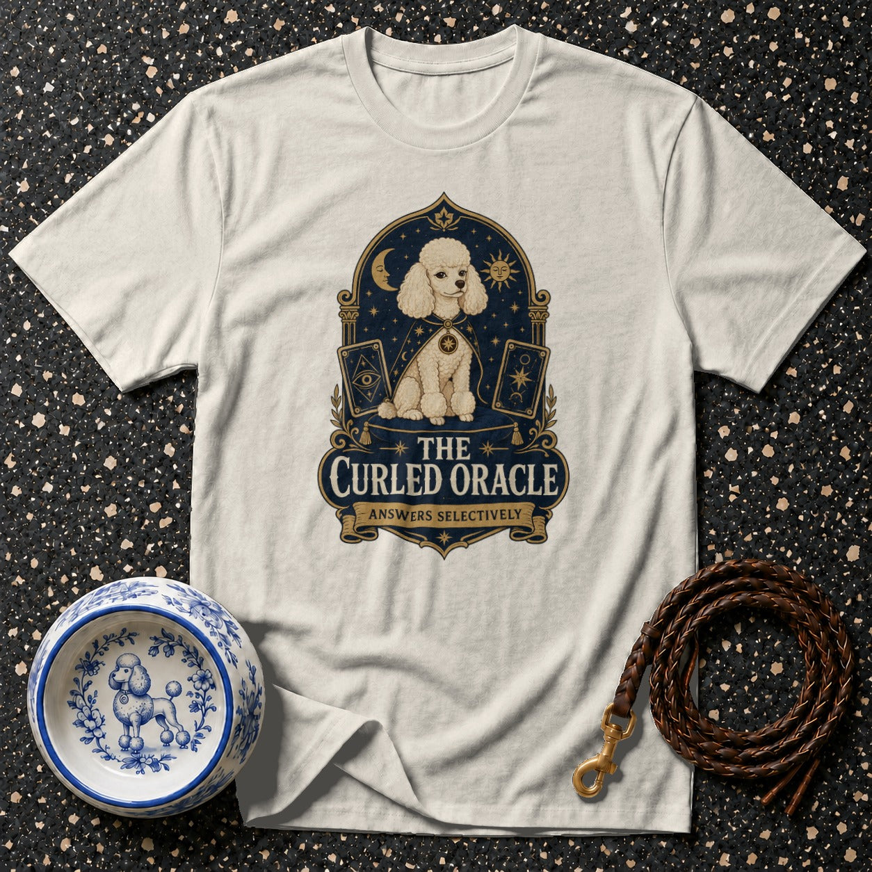 White t-shirt with a poodle oracle graphic that says "THE CURLED ORACLE ANSWERS SELECTIVELY".