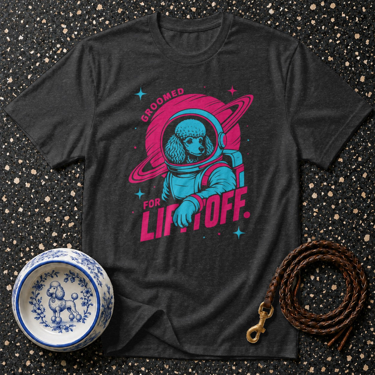 Dark t-shirt with poodle astronaut graphic and text "GROOMED FOR LIFTOFF".