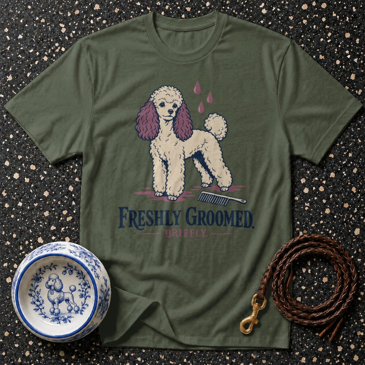 Green t-shirt with a cream poodle graphic and the text "FRESHLY GROOMED. BRIEFLY."
