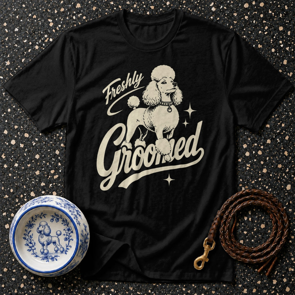Black t-shirt with cream poodle graphic and text "Freshly Groomed."