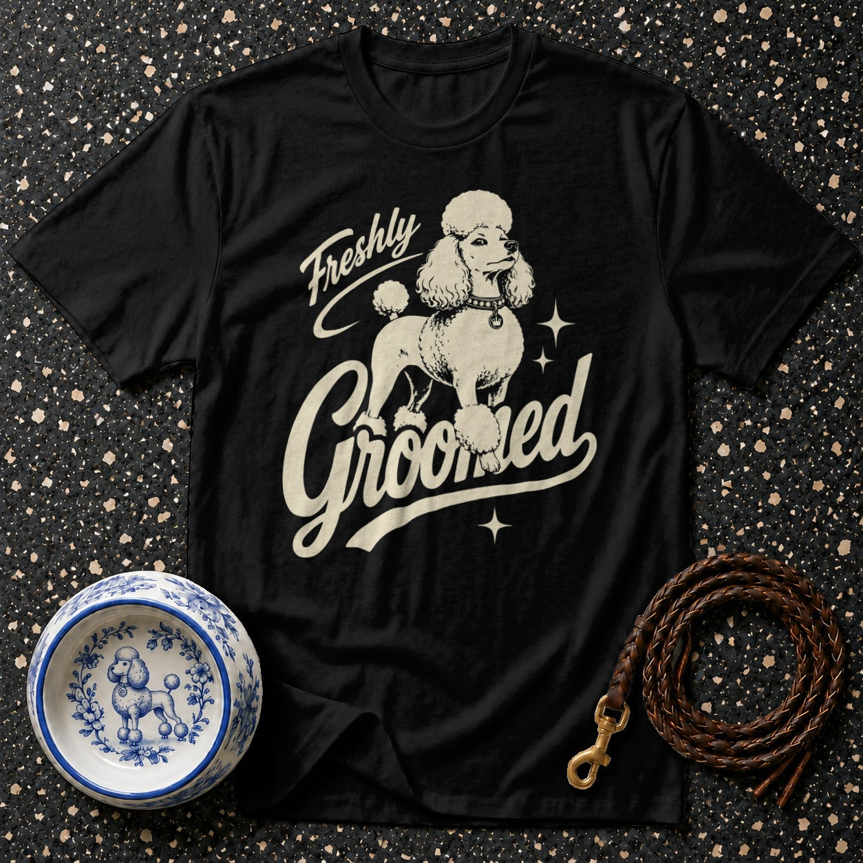 Black t-shirt with cream poodle graphic and text "Freshly Groomed."