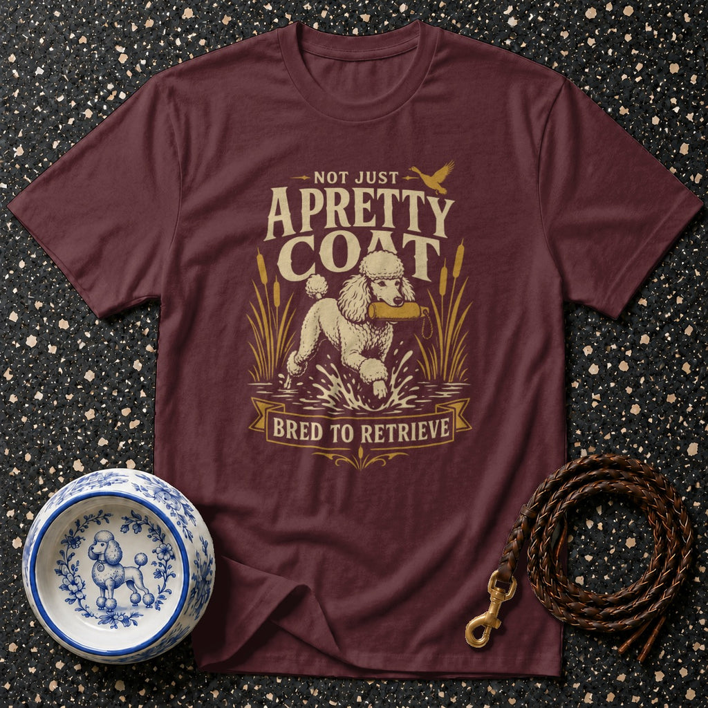 Maroon t-shirt with a poodle retrieving in water, "Not Just A Pretty Coat" text.