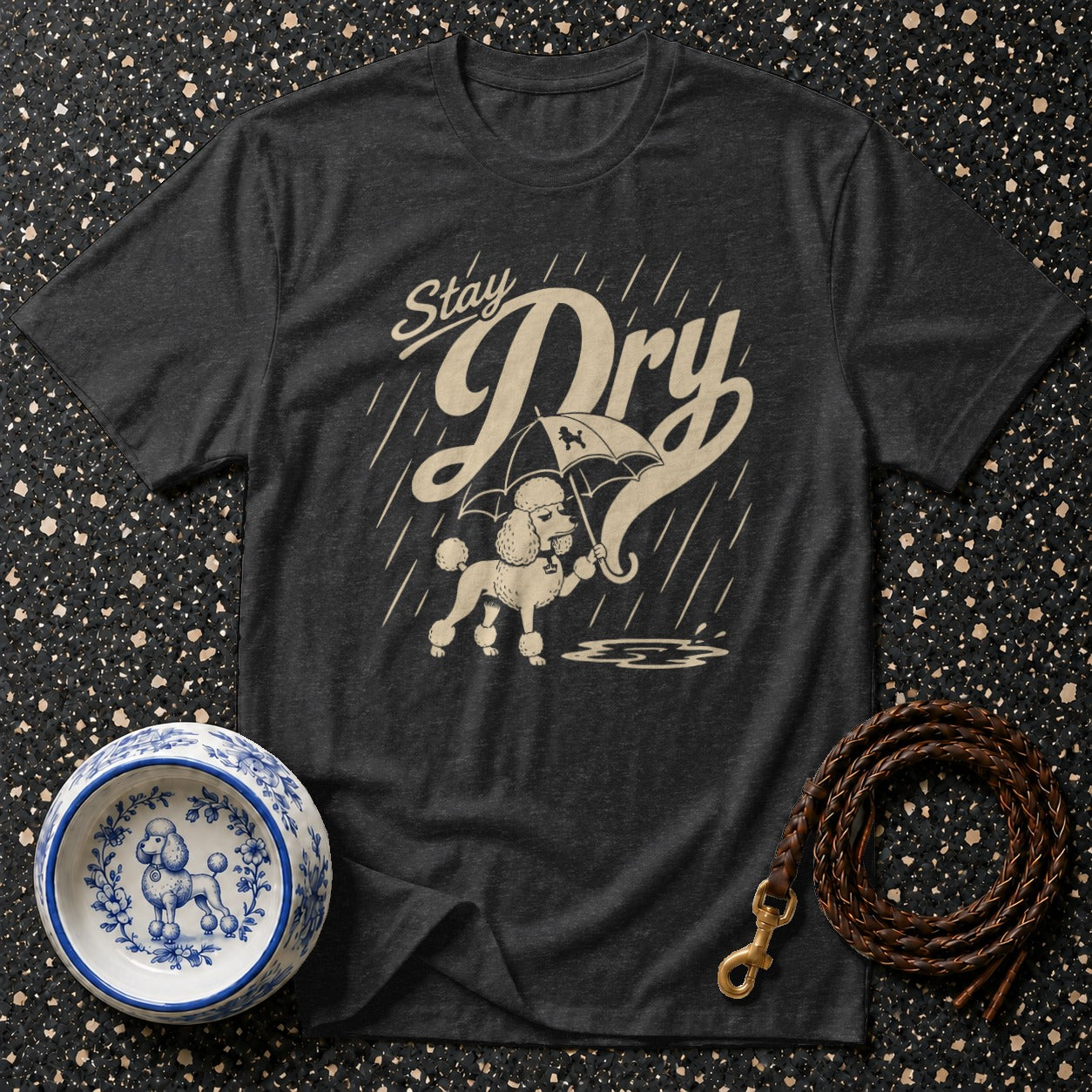 T-shirt with a poodle holding an umbrella and the text "Stay Dry" in the rain.