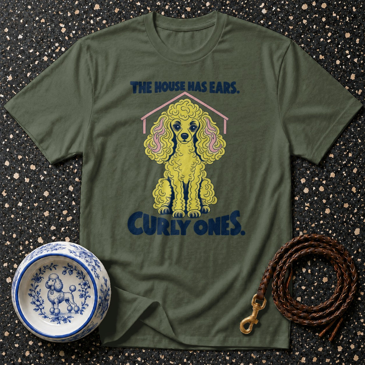 Olive green t-shirt with a yellow poodle design and the text "The House Has Ears. Curly Ones."