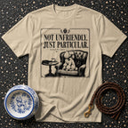 T-shirt with "Not Unfriendly. Just Particular." and poodle in armchair graphic.
