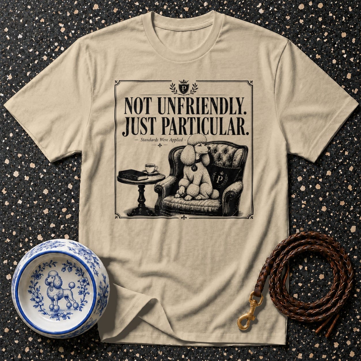T-shirt with "Not Unfriendly. Just Particular." and poodle in armchair graphic.