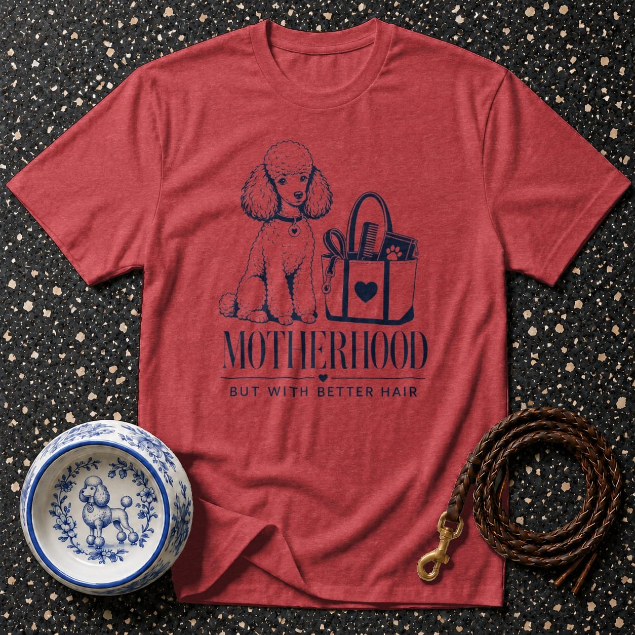 Red t-shirt with a poodle graphic and text "MOTHERHOOD BUT WITH BETTER HAIR."