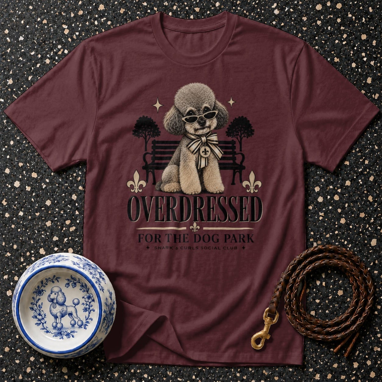 Maroon t-shirt with a poodle wearing sunglasses and a bow tie, text "OVERDRESSED FOR THE DOG PARK".