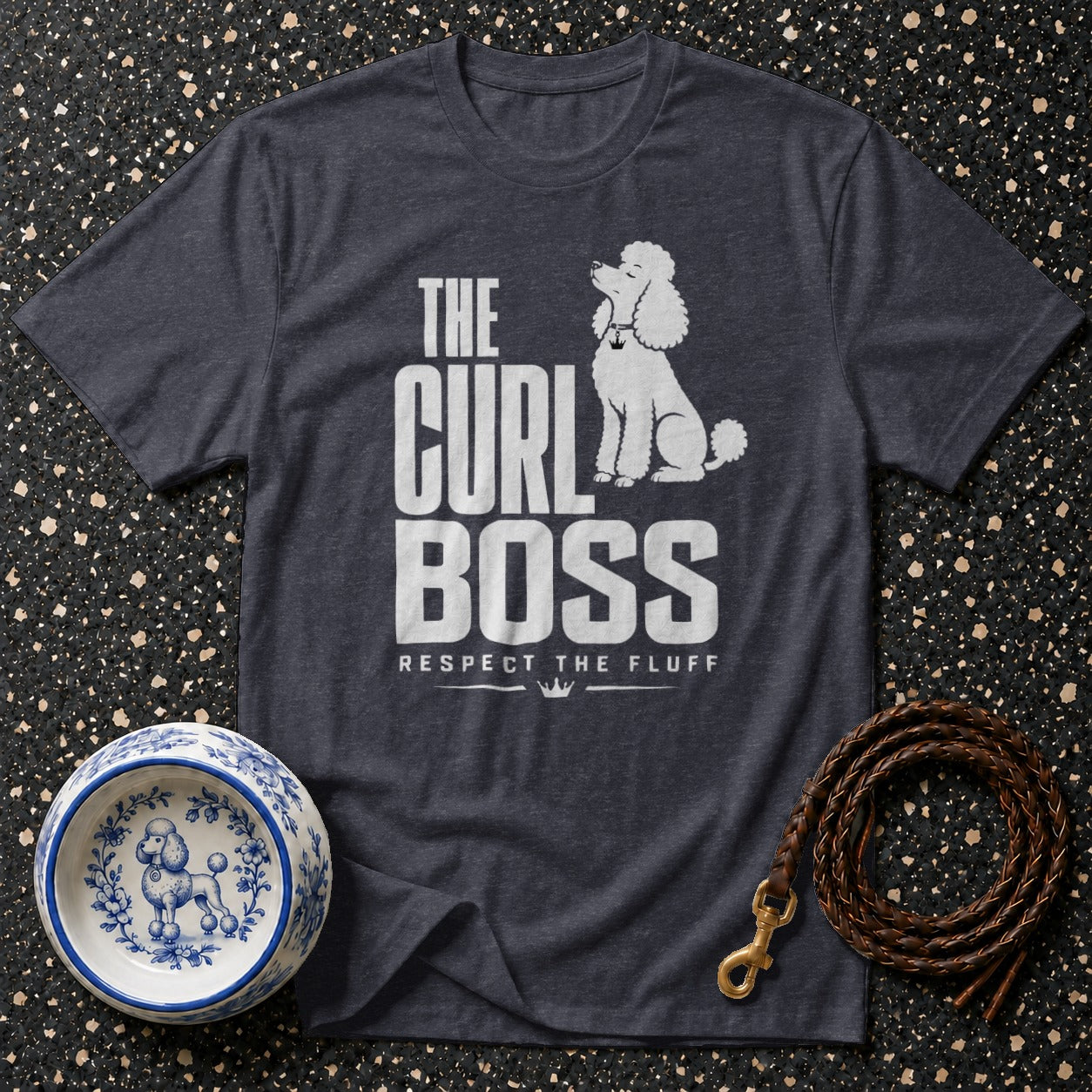 Dark charcoal t-shirt with white text "THE CURL BOSS RESPECT THE FLUFF" and a poodle graphic.