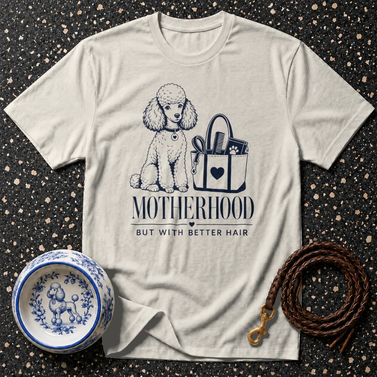T-shirt with poodle illustration and text "MOTHERHOOD BUT WITH BETTER HAIR".