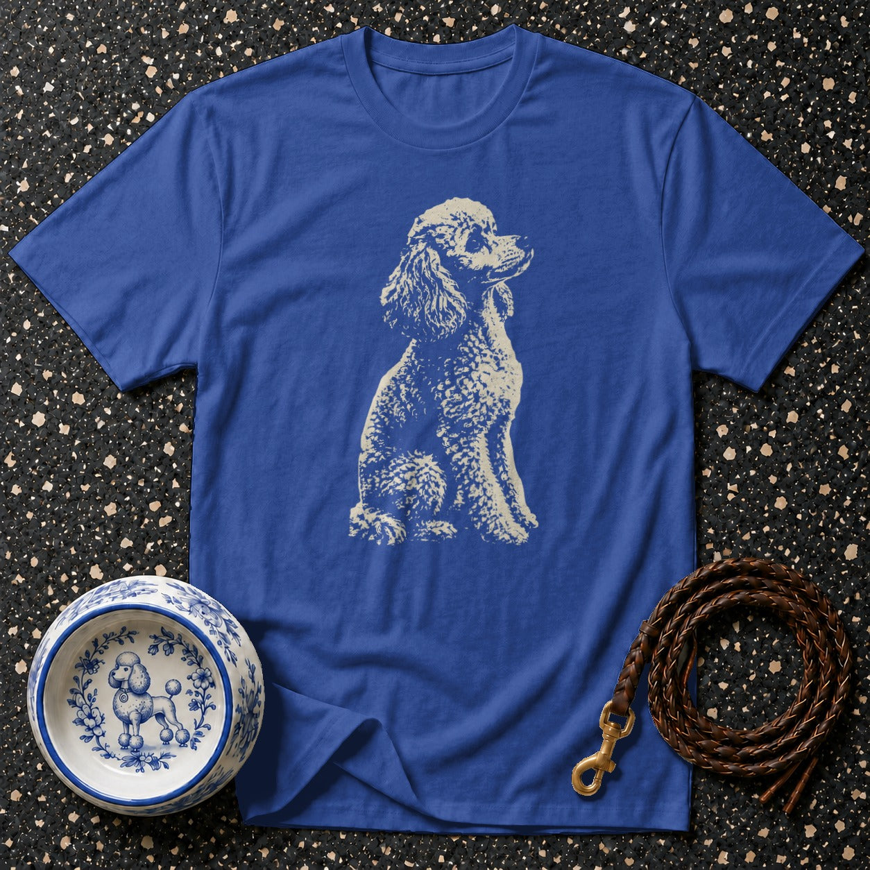 Blue t-shirt with white poodle sketch, dog bowl, and braided leash.