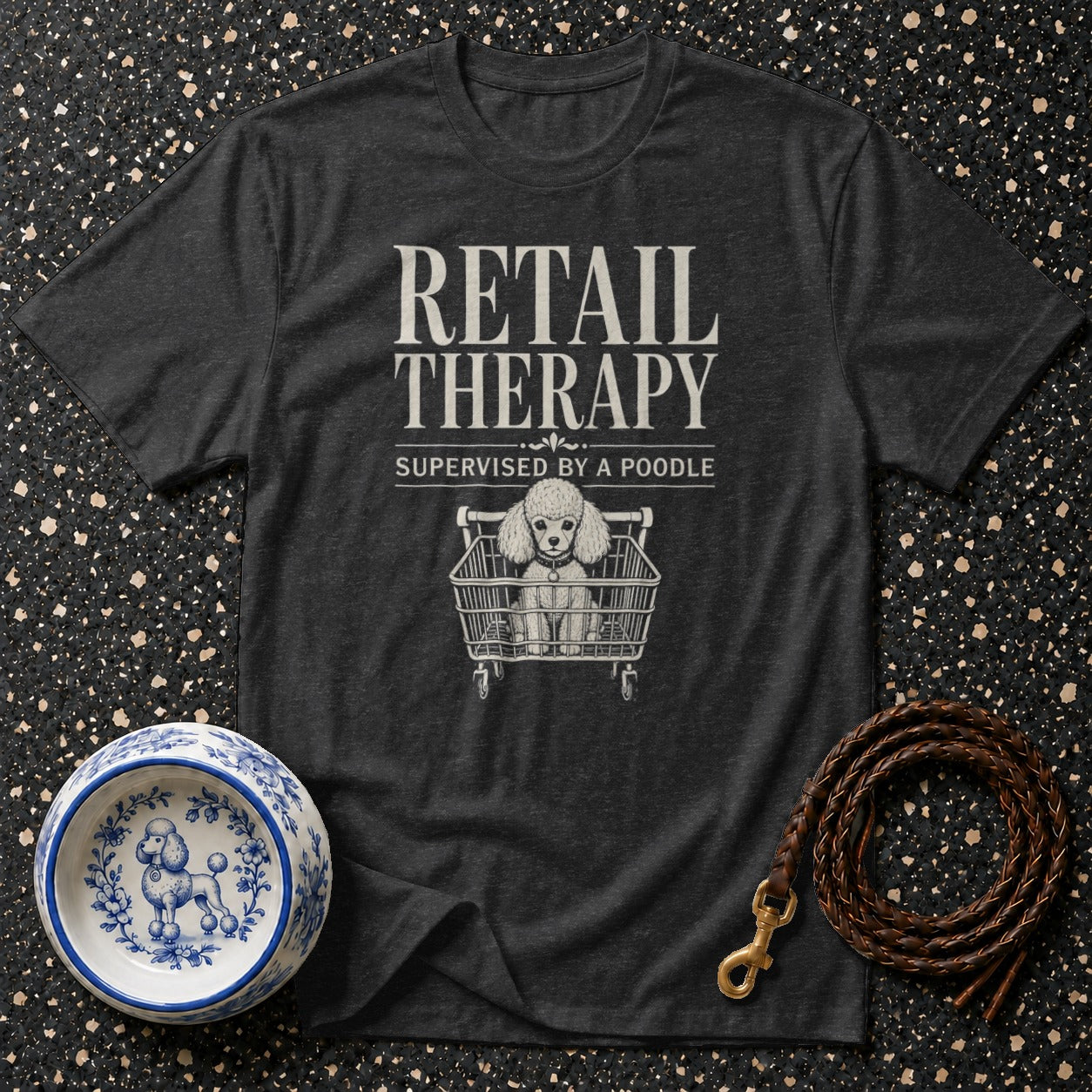 Dark grey t-shirt with "Retail Therapy Supervised by a Poodle" text and poodle in shopping cart graphic.