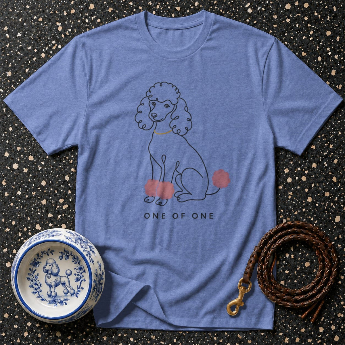 Blue t-shirt with line drawing of a poodle and text "ONE OF ONE."