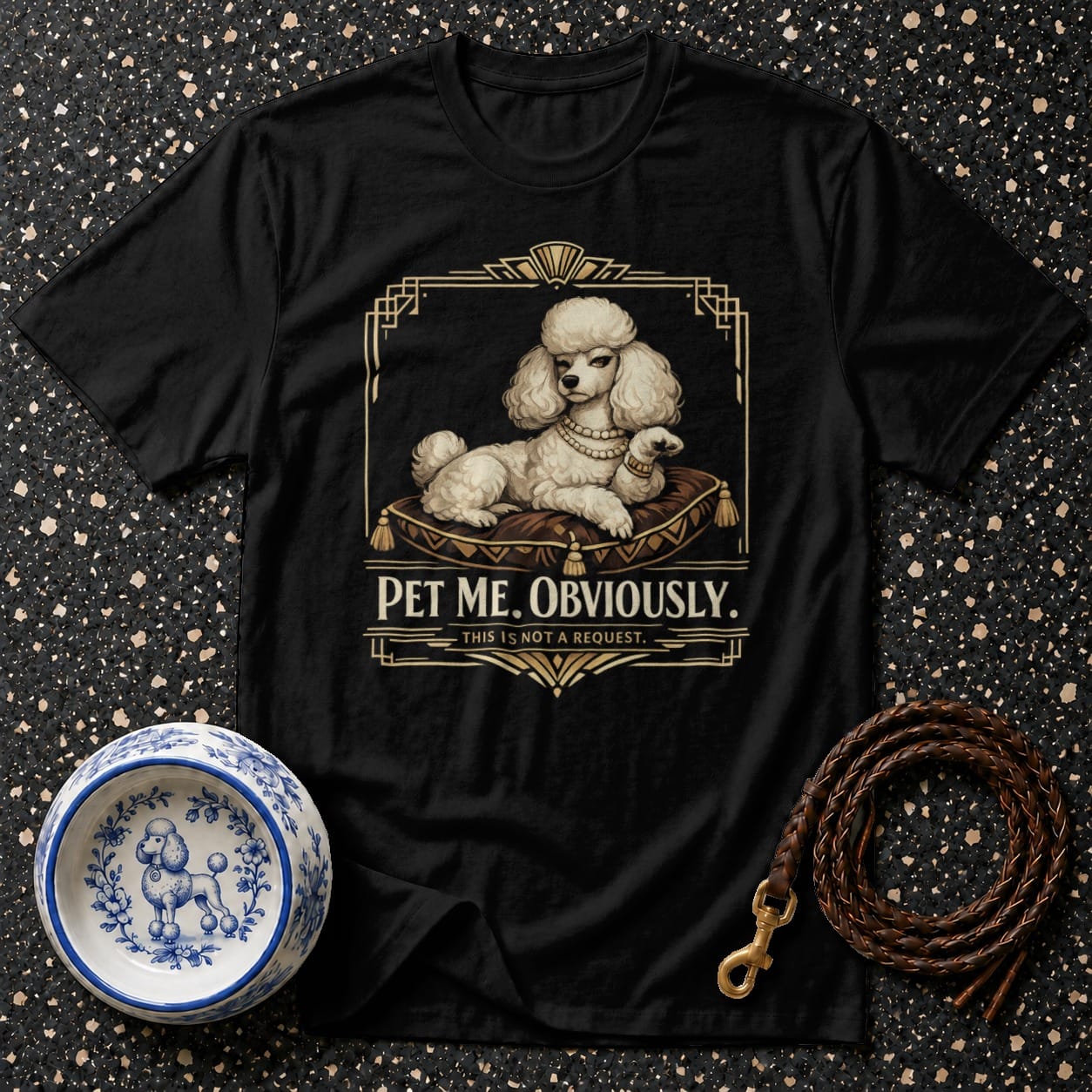 Black t-shirt with a white poodle on a cushion, reading "PET ME. OBVIOUSLY."