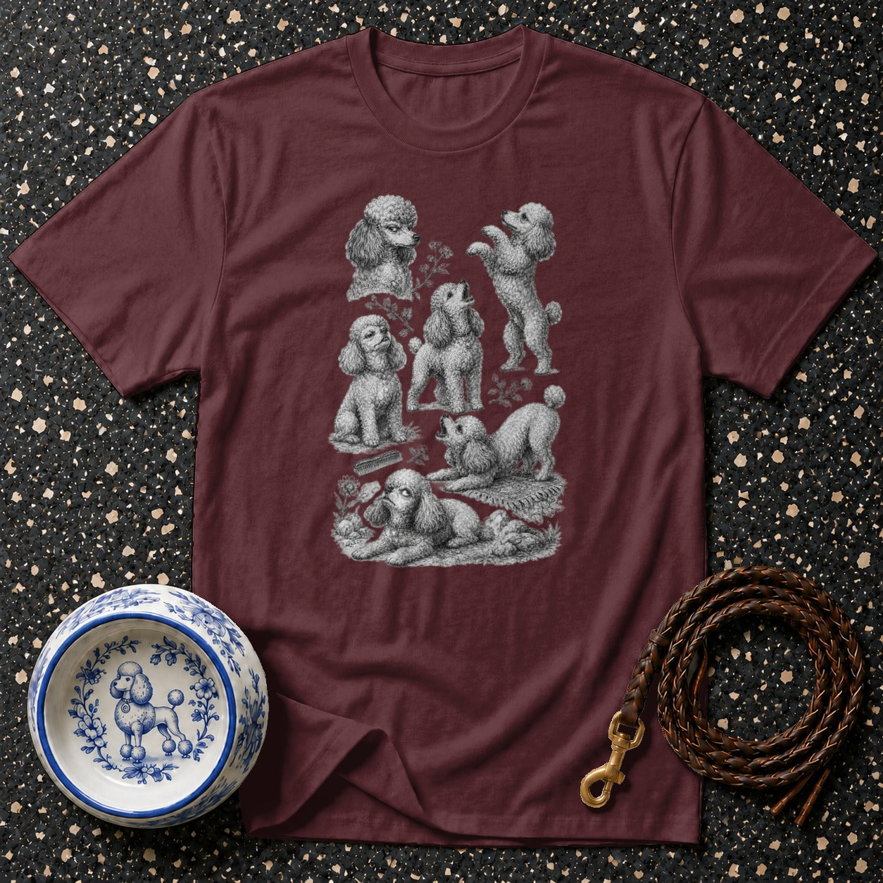Burgundy t-shirt with vintage poodle illustrations and blue and white poodle-decorated dog bowl.