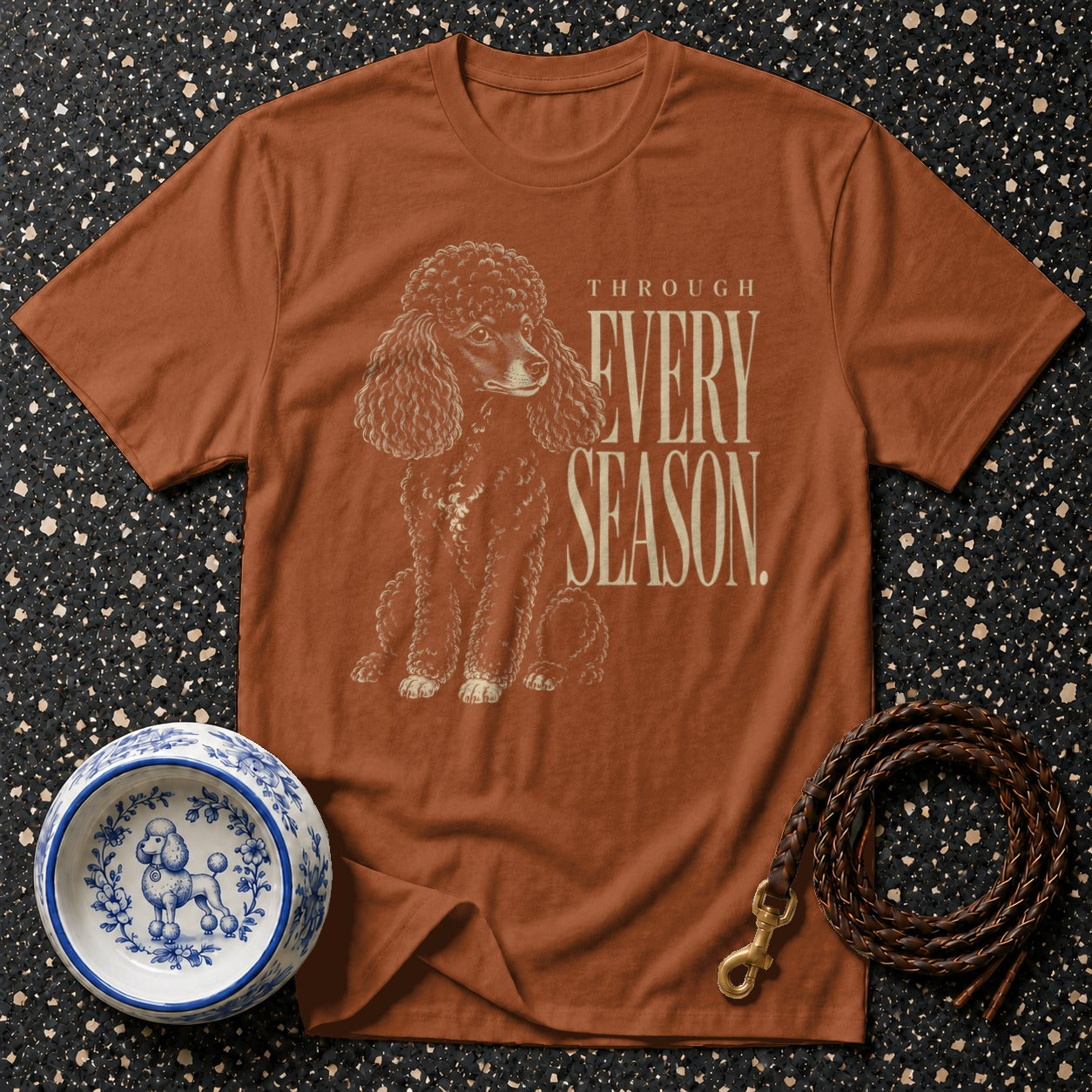Brown t-shirt with poodle graphic and "THROUGH EVERY SEASON" text.