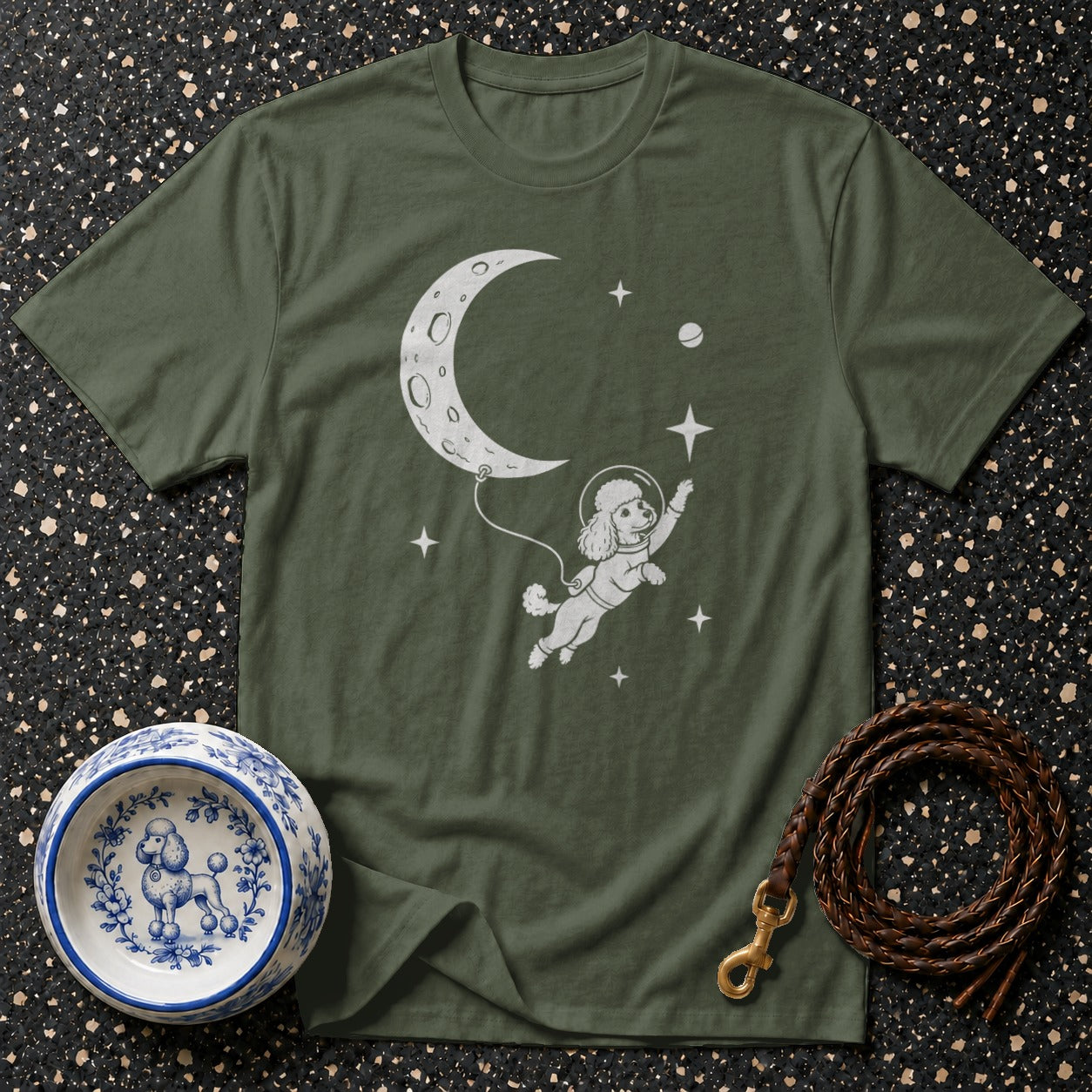 Green t-shirt with a poodle astronaut floating toward the moon with stars.