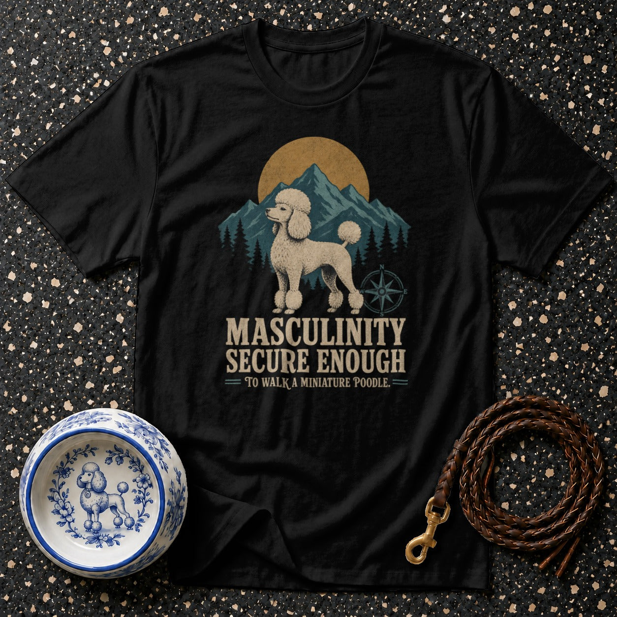 Black t-shirt with text and illustration of a poodle, mountains, and sun.