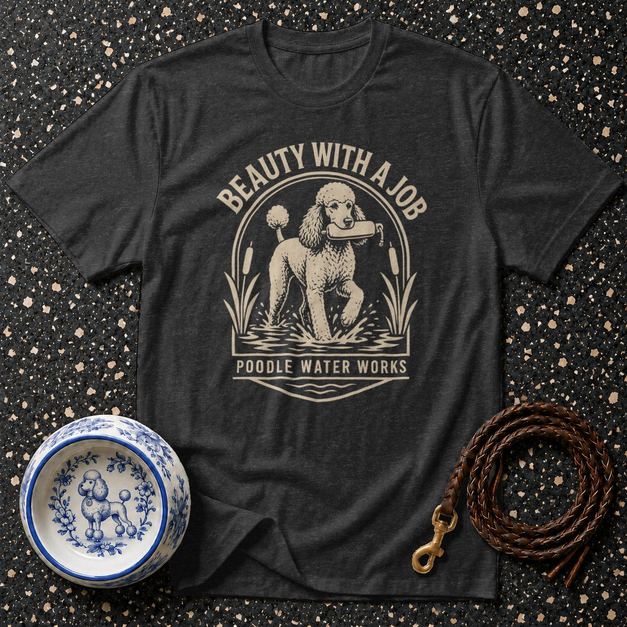 Dark t-shirt with a poodle in water, text "BEAUTY WITH A JOB" and "POODLE WATER WORKS".