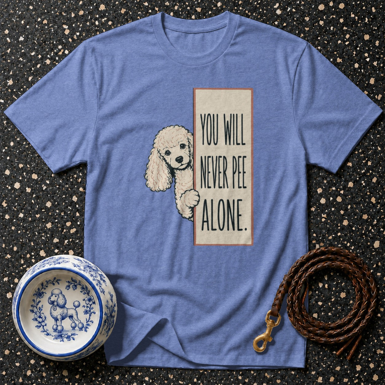 Blue t-shirt with a poodle graphic and the text "YOU WILL NEVER PEE ALONE."