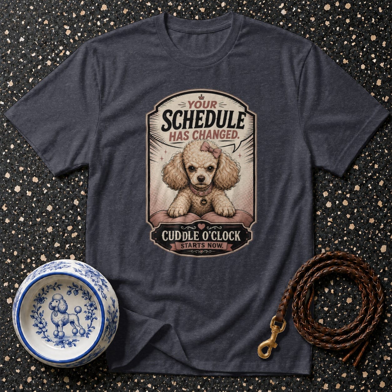 Dark t-shirt with a graphic of a poodle saying "Your schedule has changed. Cuddle o'clock starts now."