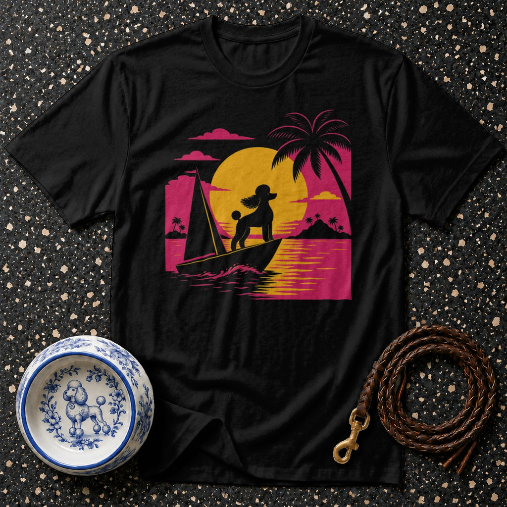 Black t-shirt with a poodle on a sailboat against a sunset and palm trees.