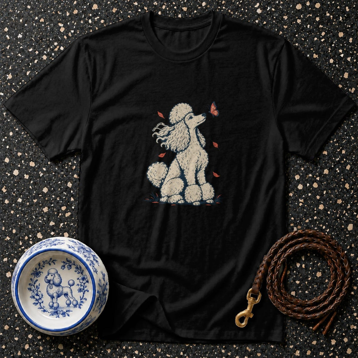 Black t-shirt with a white poodle and butterfly graphic, plus a dog bowl and leash.
