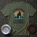 Olive green t-shirt with a design featuring a person and poodles with text "My Poodle Needs Me For Cuddles And Everything Else".