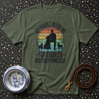Olive green t-shirt with a design featuring a person and poodles with text "My Poodle Needs Me For Cuddles And Everything Else".