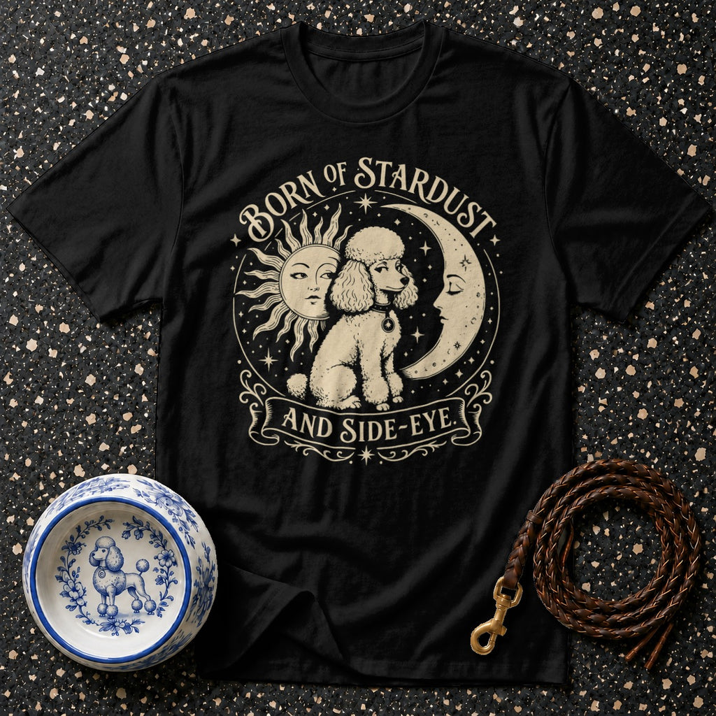 Black t-shirt with a poodle, sun, and moon graphic, "Born of Stardust and Side-Eye."