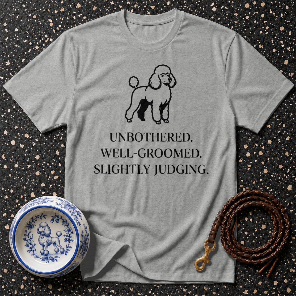 Grey t-shirt with a poodle graphic and text: "UNBOTHERED. WELL-GROOMED. SLIGHTLY JUDGING."