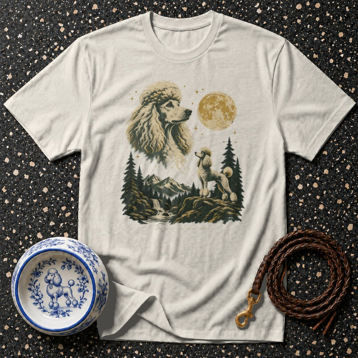 T-shirt with graphic of two poodles in a mountain landscape with moon and stars.