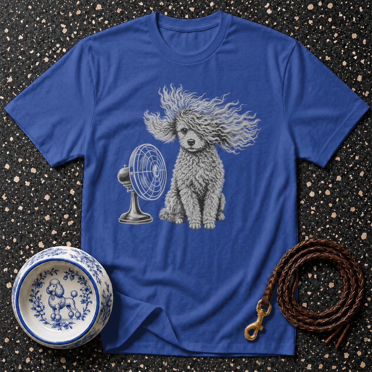 Blue t-shirt with poodle illustration, fan, dog bowl, and leather leash.