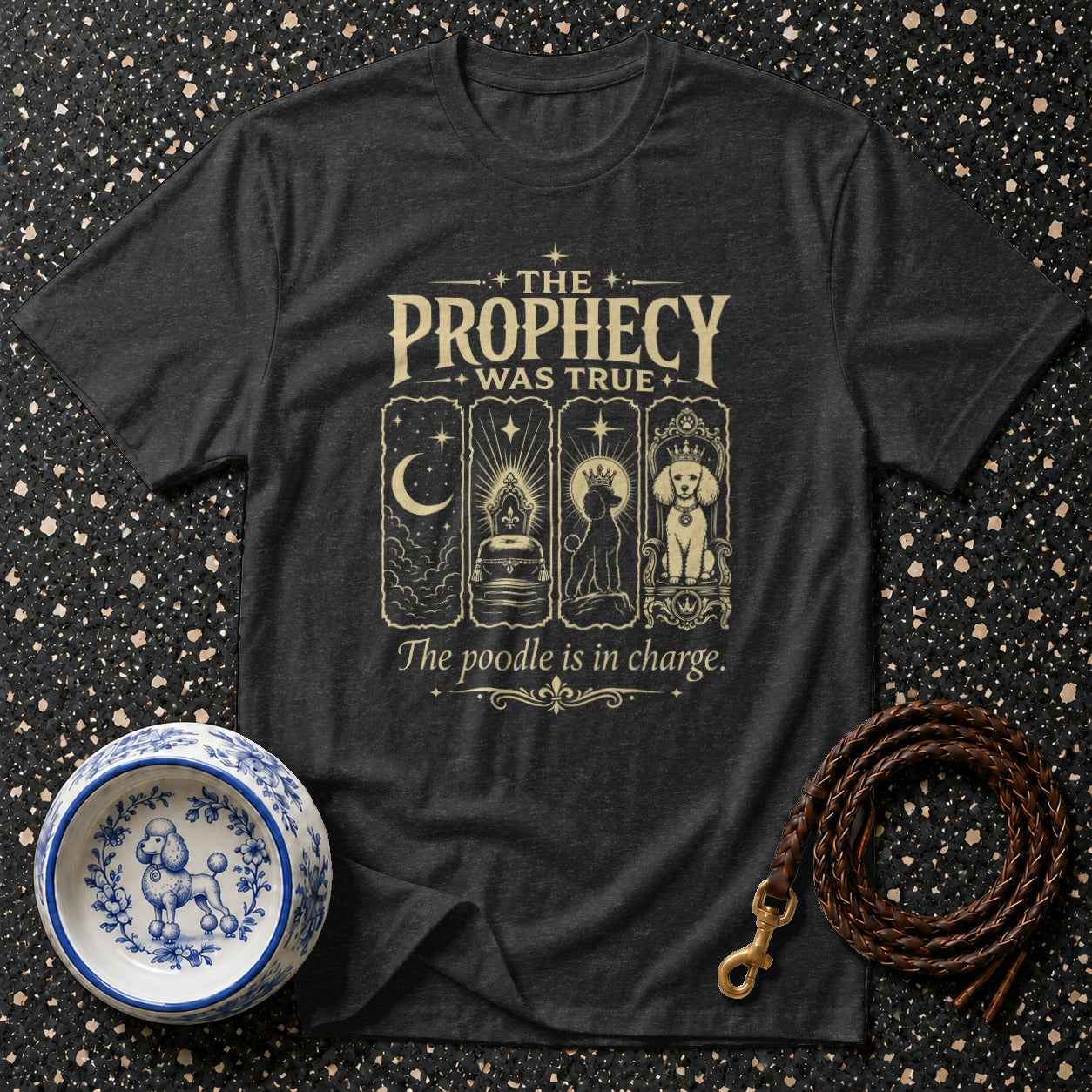 Dark t-shirt with "The Prophecy Was True" and "The poodle is in charge" text.