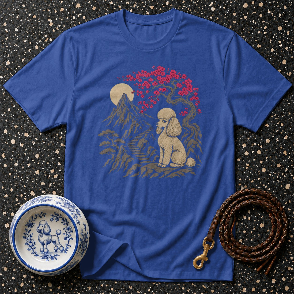 Blue t-shirt with poodle, mountains, cherry blossoms, and moon graphic.