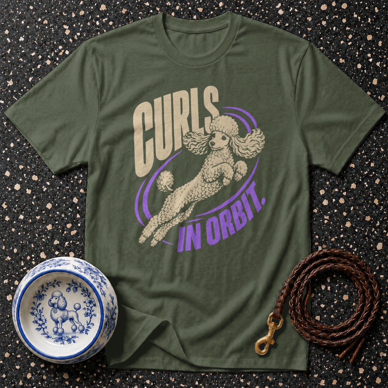 Green t-shirt with a poodle design that says "Curls In Orbit".